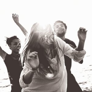 Group of multi-ethnic friends dancing on the beach Group of multi-ethnic friends dancing on the beach.